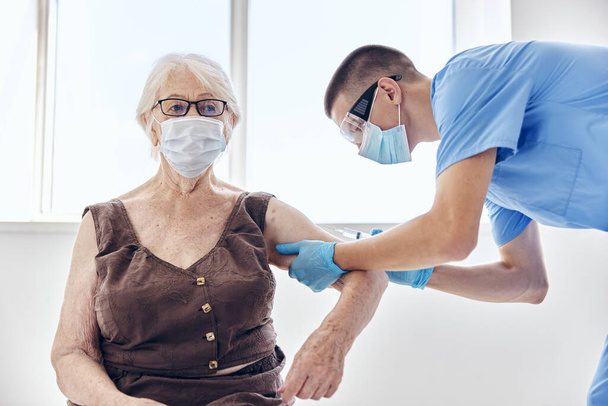 male doctor giving an injection immunity protection patient treatment - Photo, Image