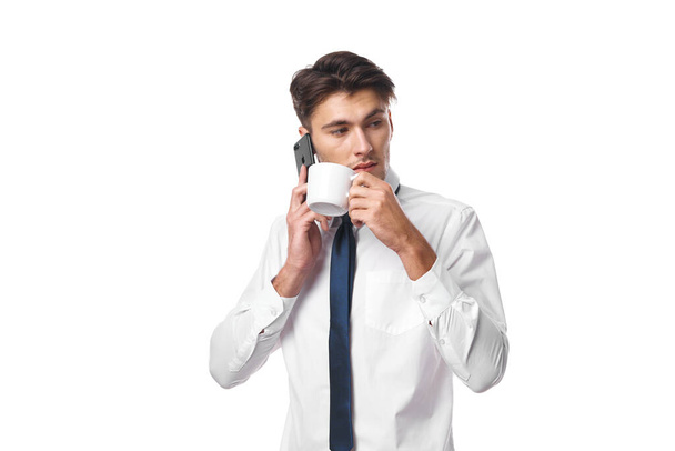 businessmen a cup of coffee talking on the phone official isolated background - Фото, изображение