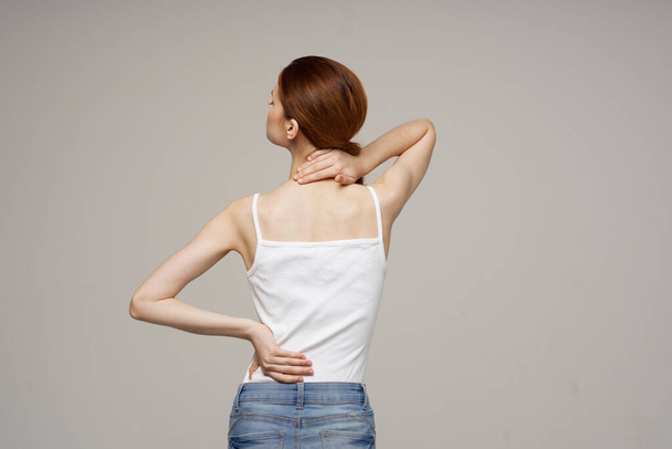 disgruntled woman pain symptoms in the joints arthritis light background - Foto, imagen