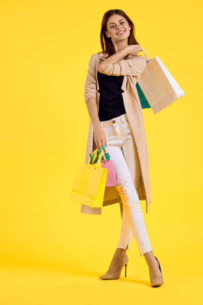 smiling woman multicolored packs emotions shopping fashion studio model - Fotografie, Obrázek
