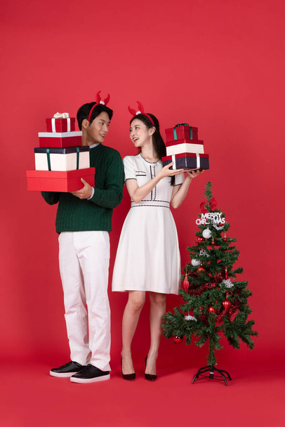 Asian Korean couple in winter fashion with rudolph hairband, Christmas shopping event concept - Foto, Imagem