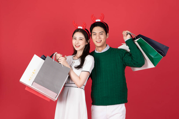 Asian Korean couple in winter fashion, Christmas shopping event concept - Фото, изображение