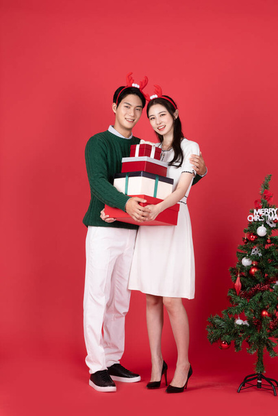 Asian Korean couple in winter fashion with rudolph hairband, Christmas shopping event concept - Foto, Imagen