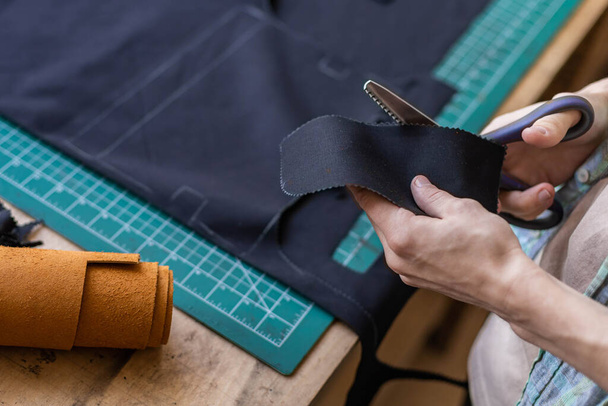 Craftsman drawing scheme lining for bag on tissue creating leatherwork at studio leather workshop - Fotoğraf, Görsel