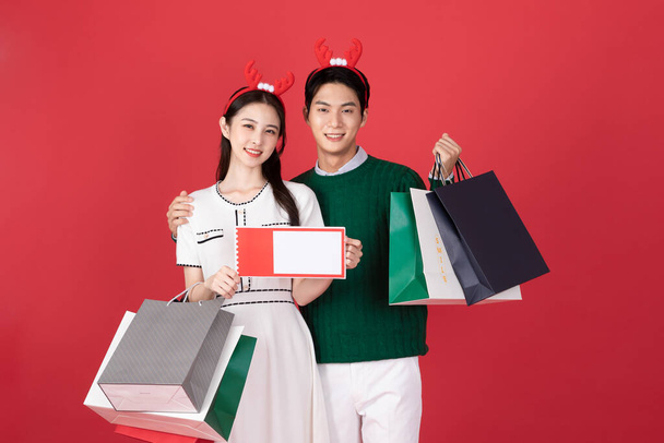 Asian Korean couple in winter fashion, Christmas shopping event concept - 写真・画像