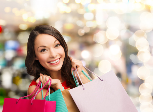 smiling young woman with shopping bags - Photo, image