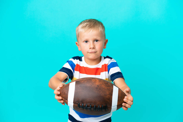 Little Russian boy Playing rugby over isolated background - Photo, Image
