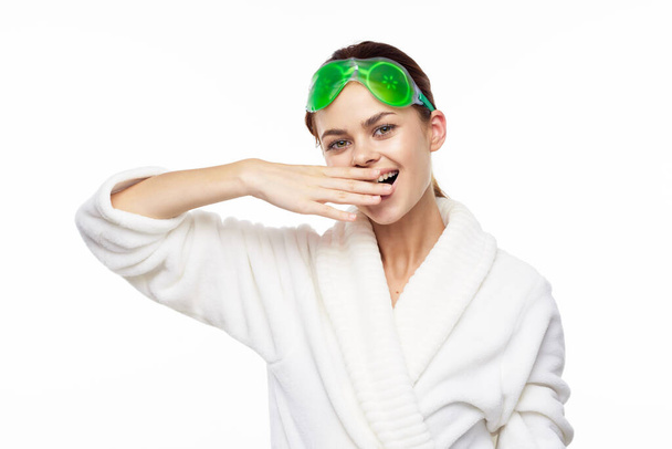 cheerful woman in a white robe facial care rejuvenation lifting - Foto, imagen