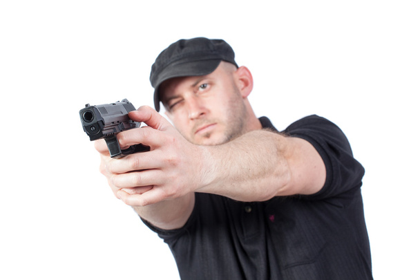 Man pointing gun, isolated on white. Focus on the gun - Фото, изображение