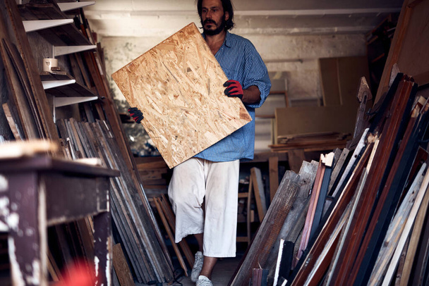 Man assembling furniture and fixing it - hobby concept. - 写真・画像