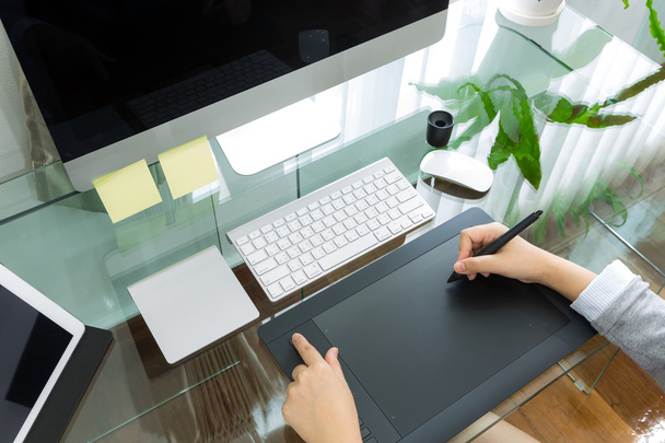 Business woman  graphic designer working in office using tablet  - 写真・画像