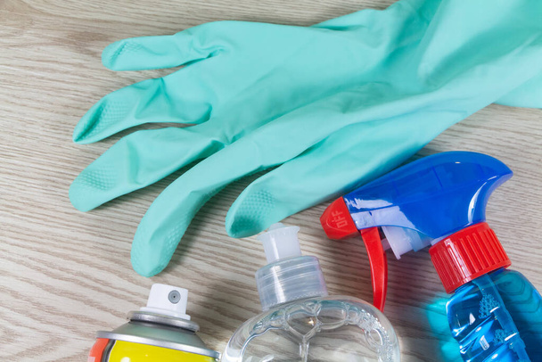 Cleaning products and rubber glove on wooden background - Photo, Image