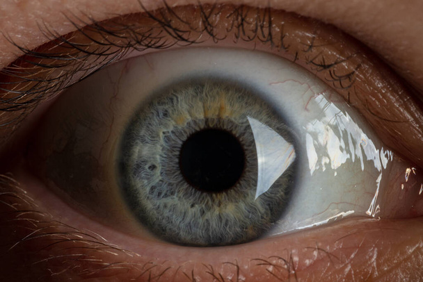 blue pupil on the eye close-up - Photo, image
