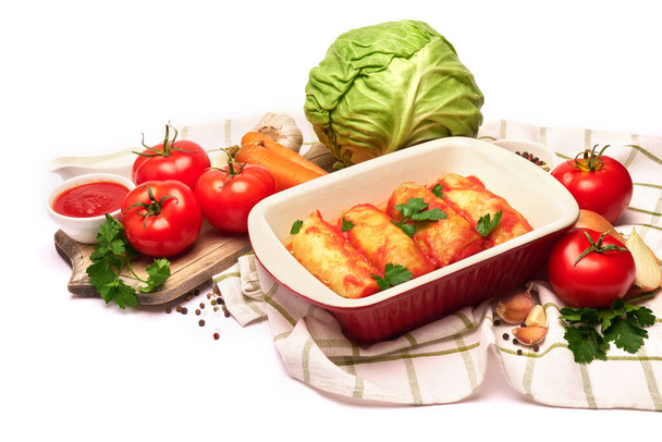 cabbage rolls stuffed with ground beef and rice with sour cream in a baking dish and ingredients - 写真・画像
