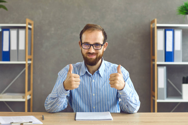 Happy young businessman or office worker showing that hes satisfied with work results - Photo, Image
