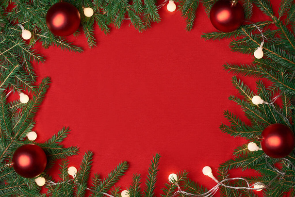 frame of a Christmas wreath on a red background. - Valokuva, kuva