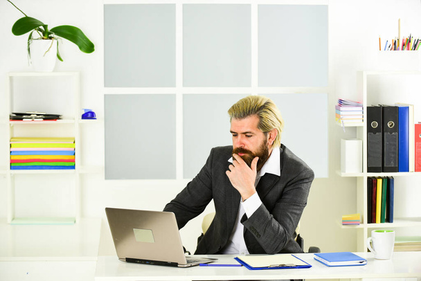 Manager solving business problems. Raising standards. Stock market. Office staff concept. Office routine. Businessman in charge of business solutions. Risky business. Man bearded boss sit with laptop - Foto, Bild