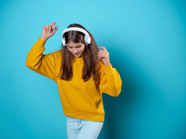 Music lover, a young woman with headphones, listening to music. - Foto, afbeelding
