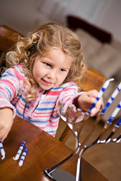 Hanukkah: Little Girl Putting Candles Into Menorah - Photo, image
