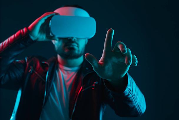 Man in VR goggles interacting with cyberspace - Φωτογραφία, εικόνα