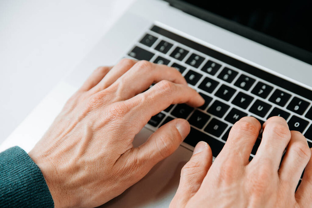 close up. casual male typing on a laptop keyboard. - Foto, Bild