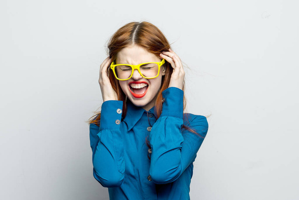 woman in blue shirt yellow glasses charm glamor - Fotografie, Obrázek