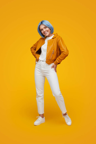 Smiling stylish woman with blue hair in studio - Фото, изображение