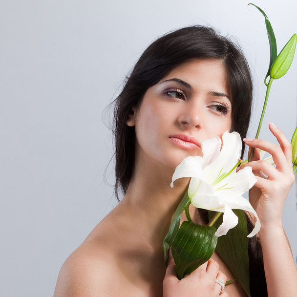 Beautiful woman with lily - Фото, изображение