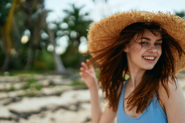 cheerful woman in a beach hat by the ocean island summer - Photo, Image