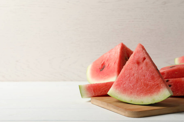 Delicious fresh watermelon slices on white wooden table. Space for text - 写真・画像