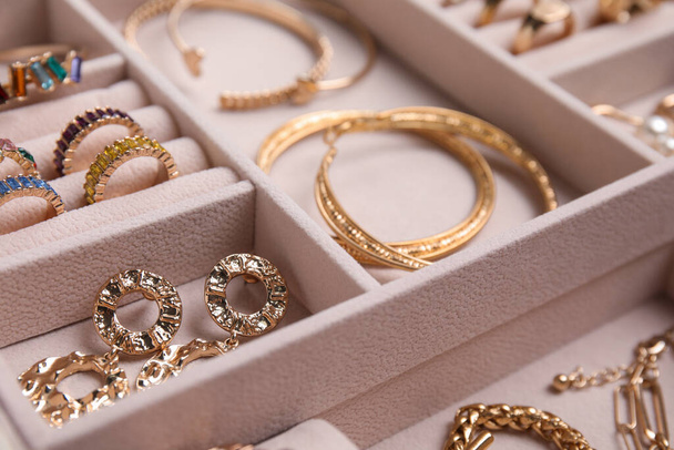 Jewelry box with stylish golden bijouterie, closeup view - Photo, Image