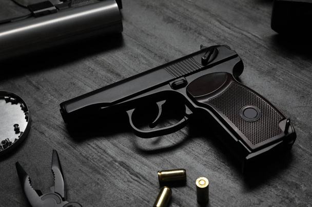 Standard handgun on dark table. Semi-automatic pistol - Foto, Imagem