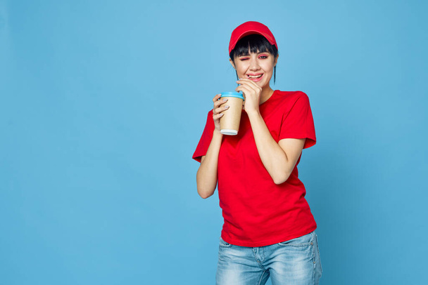 woman in red uniform cup of coffee blue background fun - Φωτογραφία, εικόνα