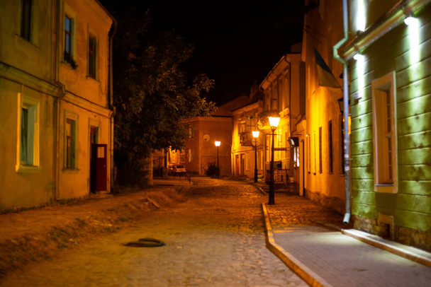 View on the street in Kamyanets-Podilskyi at night - Фото, зображення