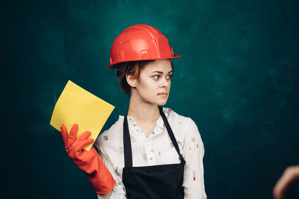 woman in black apron orange hard hat protection cleaning - 写真・画像