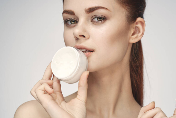 woman with jar of cream makeup face skin care close-up - Fotó, kép