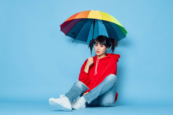 cheerful woman in red t-shirt rainbow color umbrella fashion - Photo, image