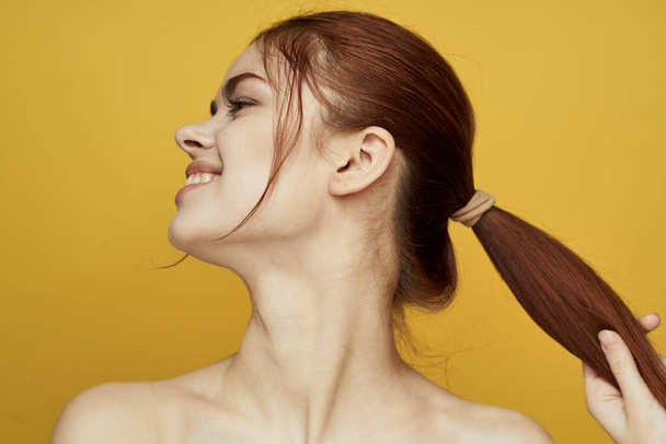 woman with bare shoulders clean skin hairstyle posing yellow background - Fotó, kép