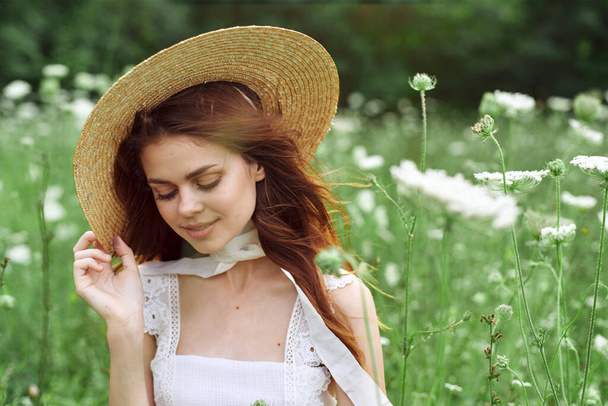 pretty woman in white dress and hat posing flowers nature - Photo, Image