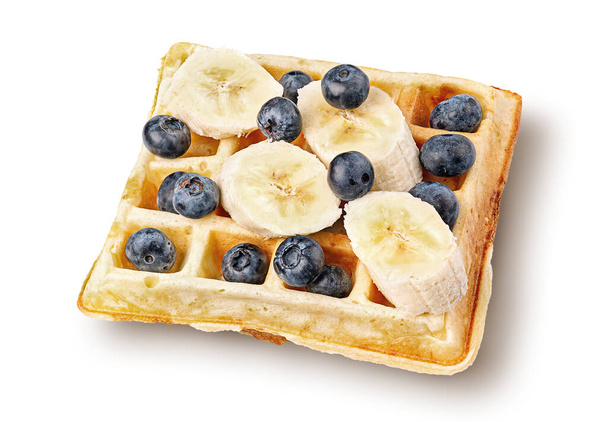 French waffles with blueberries and bananas top wiev isolated on white background - Foto, afbeelding