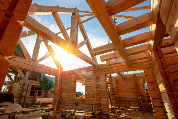 Nowy dom drewniany drewniana konstrukcja wnętrz z odsłoniętym dachem ramowym ze światłem słonecznym - Zdjęcie, obraz