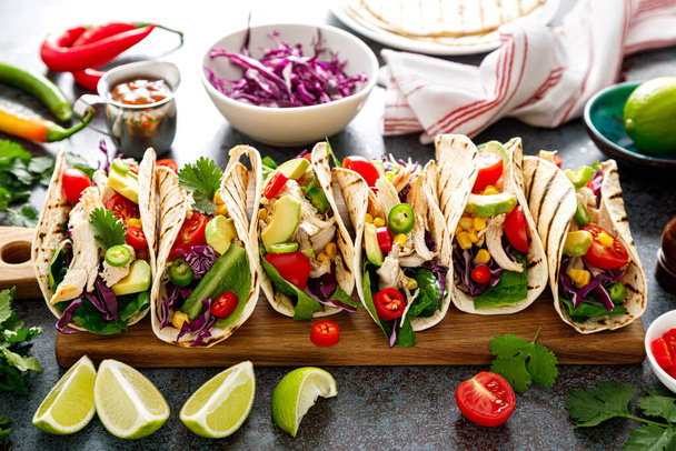 Chicken tacos with grilled meat, avocado, fresh vegetable salad and sauce salsa - Zdjęcie, obraz