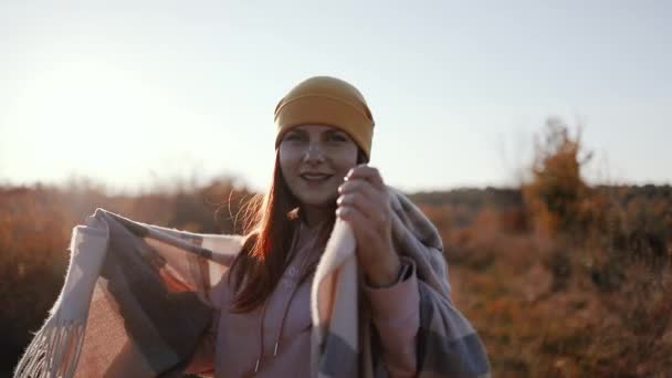 Happy free woman wearing yellow hat and cozy clothes with cashmere scarf has fun outdoors in autumn park - Záběry, video
