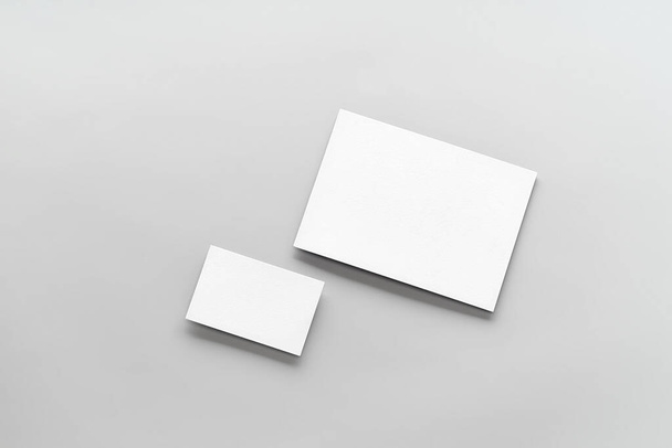 Modern business card mockup template on gray background. Top view flat lay of two cards. Mock-up design for branding, advertising and design - Photo, image
