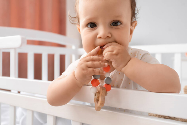 Cute little baby with toy in crib, closeup - Foto, imagen
