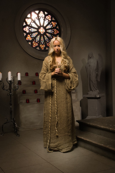 Nonne betet in einer mittelalterlichen Kirche - Foto, Bild