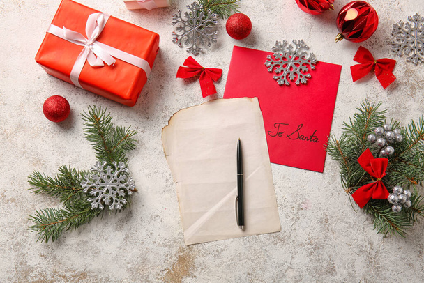Christmas decor, blank letter, pen and envelope with text TO SANTA on light background - 写真・画像