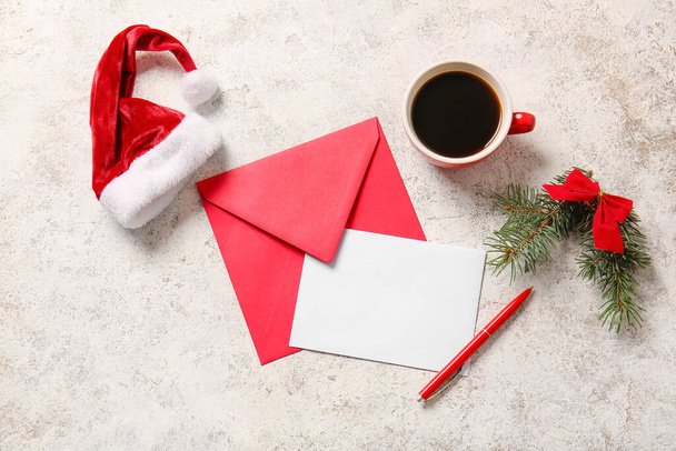 Christmas decor, cup of coffee, pen, envelope and blank letter on light background - Photo, Image