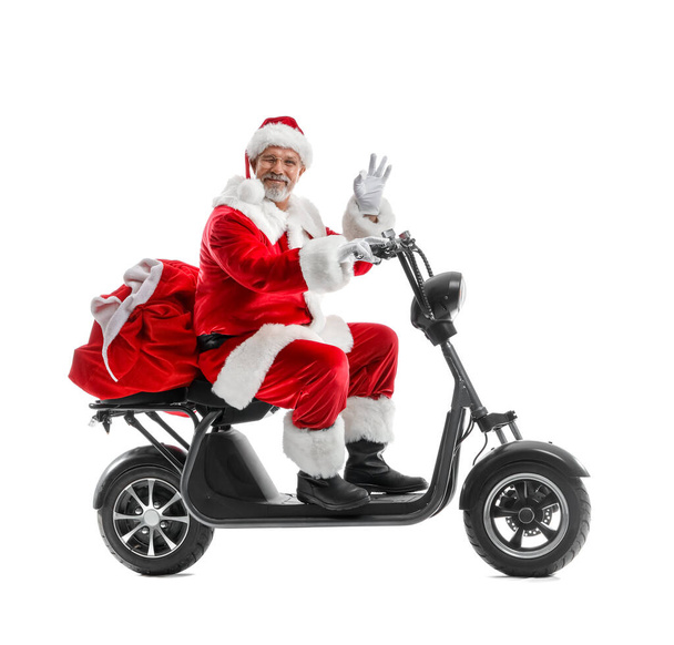 Papai Noel equitação scooter elétrico e mão acenando no fundo branco - Foto, Imagem