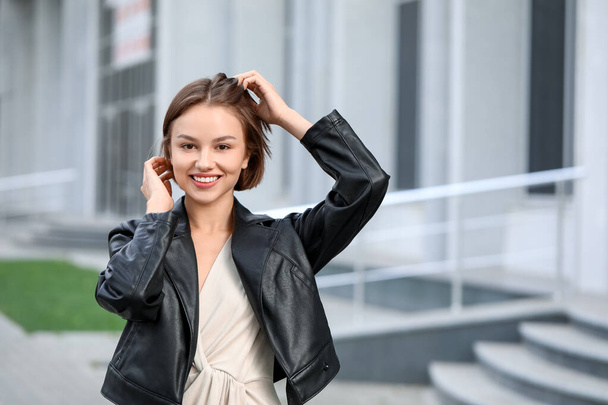 Happy fashionable woman in leather jacket outdoors - Zdjęcie, obraz